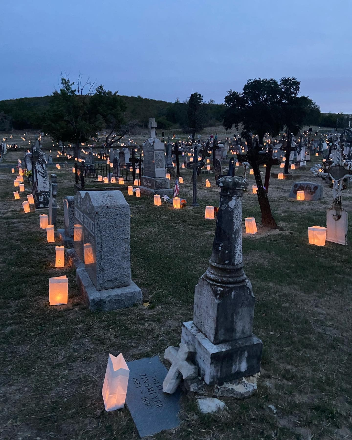 luminaries in cemetary at dusk